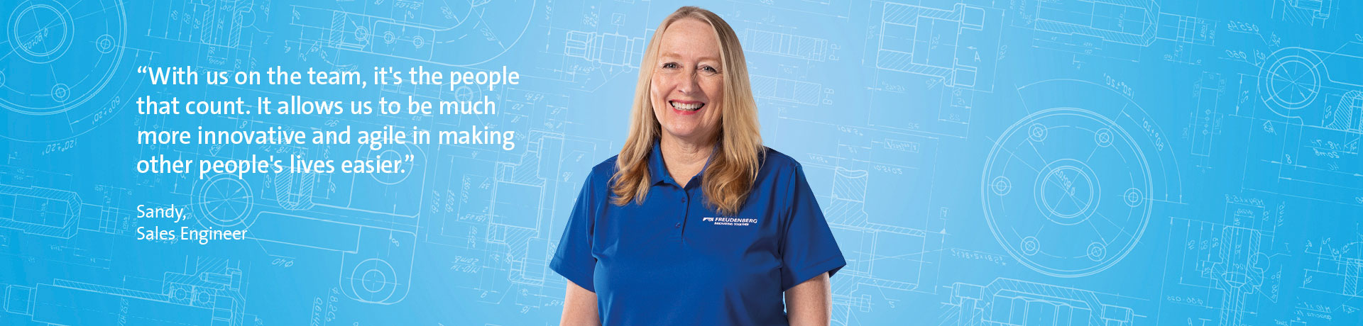 A blonde woman smiling at the camera, wearing a blue shirt and standing in front of a blue background. There is a quote in the left part of the picture.