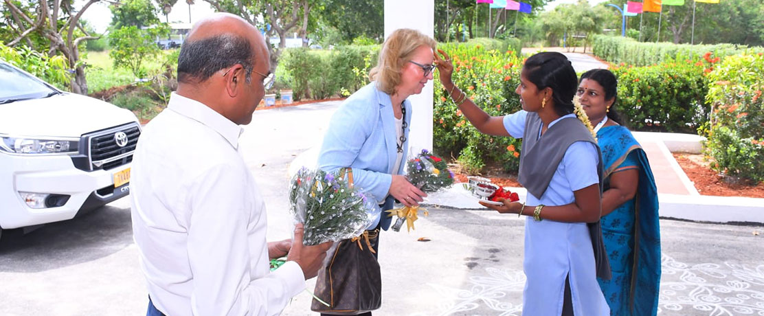 Esther Maria Loidl are welcomed by students at the entrance of the Training Center