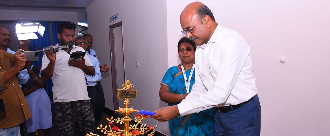 A man lights up a traditional lamp