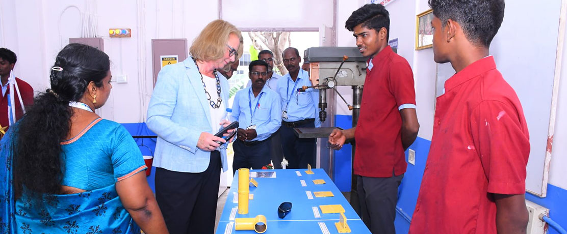 Students show Esther Maria Loidl workpieces that they have made