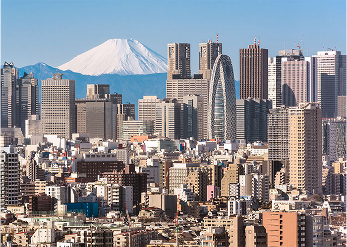 Photo showing the skyline of a Japanese city with clear view of Mount Fuji
