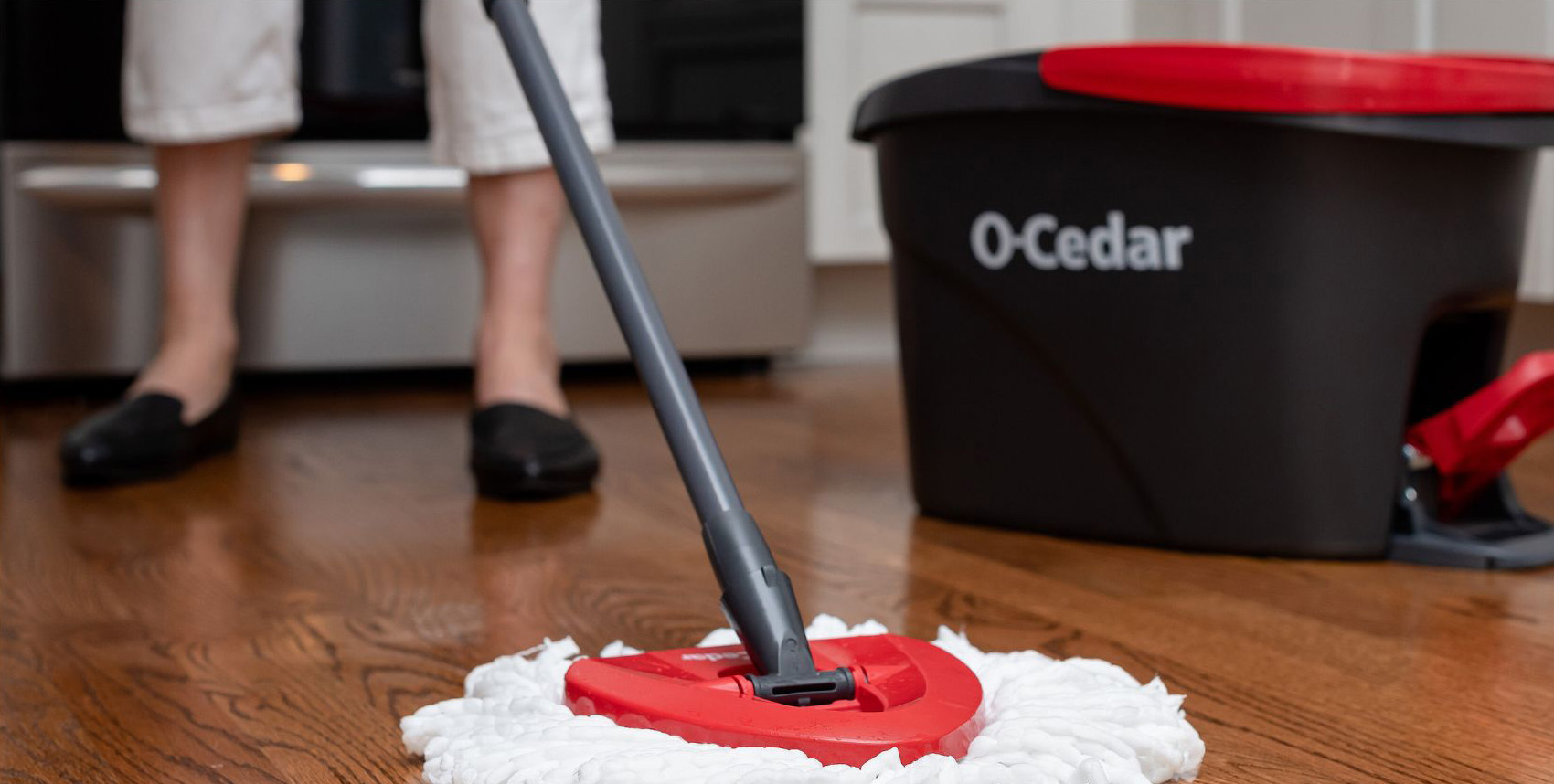 an O'Cedar bucket with a mop on the floor