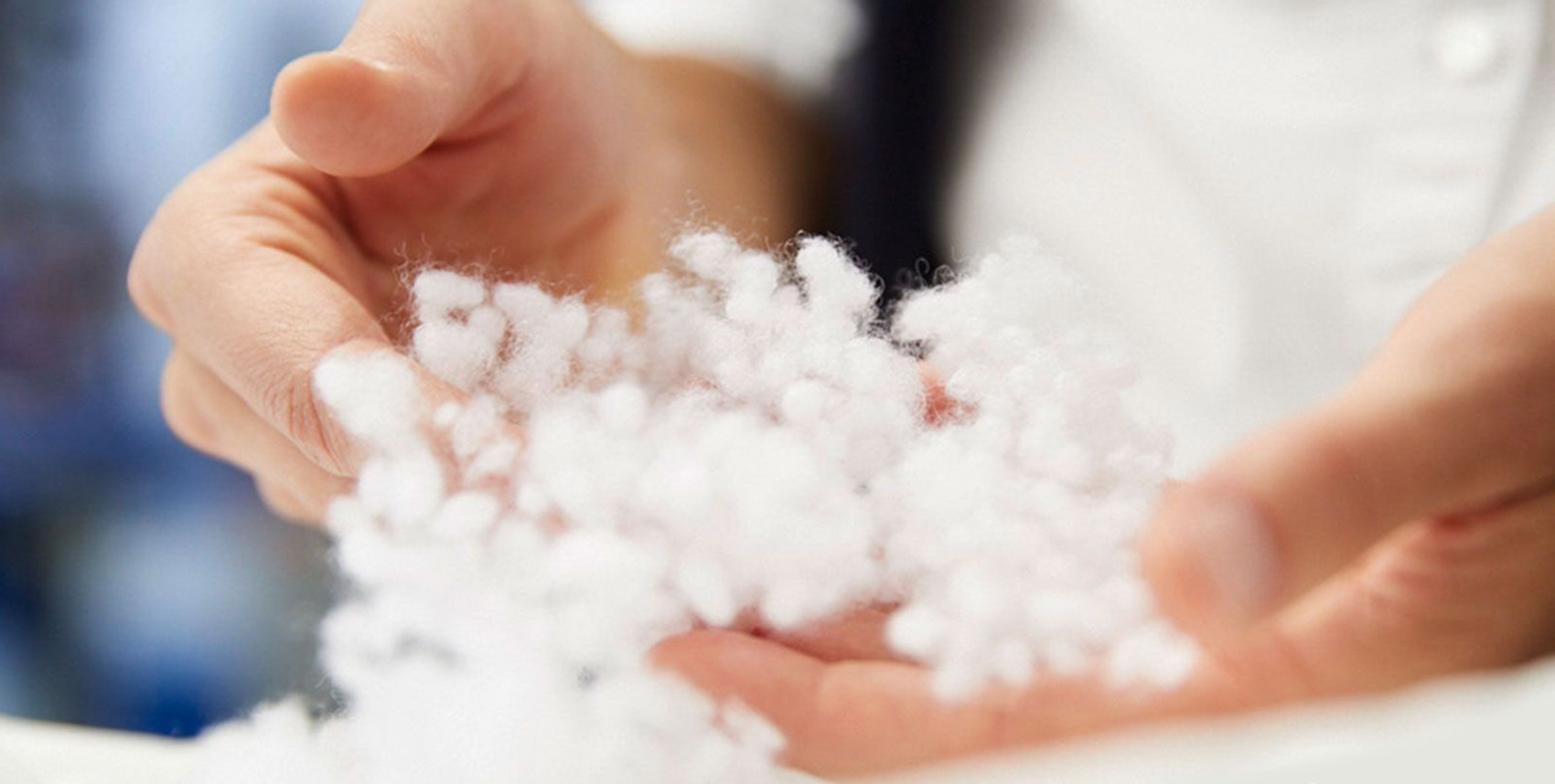two hands holding a white padding material