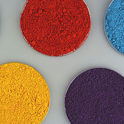 4 glass containers with powders of different Colors