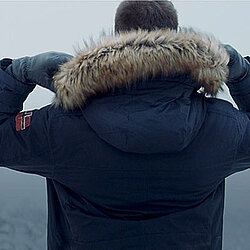 a man from behind, wearing a dark blue jacket