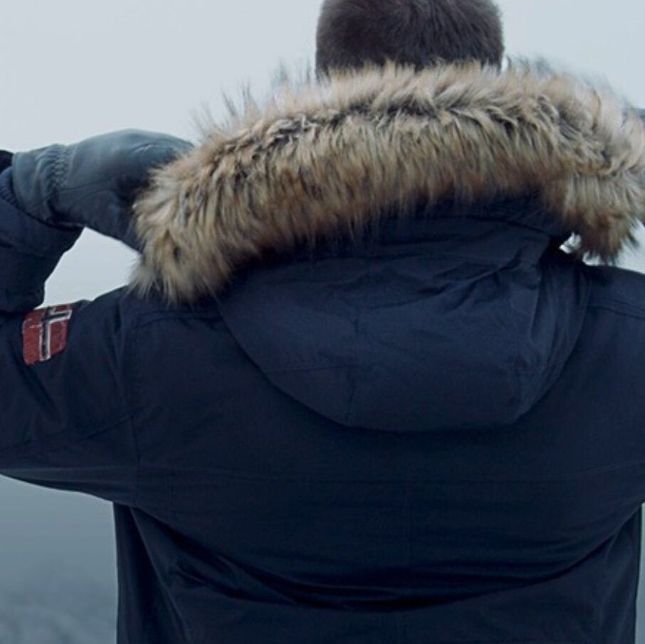 a man from behind, wearing a dark blue jacket