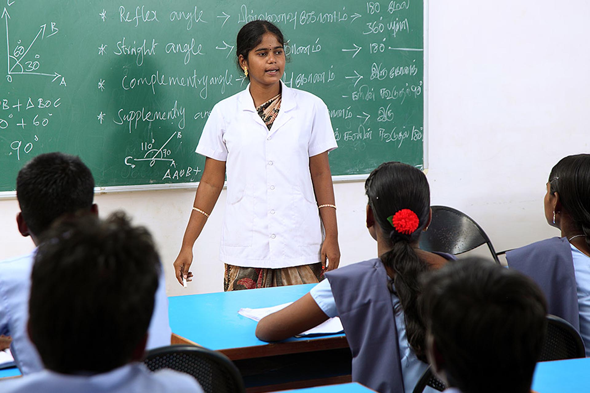 A female teacher trains pupils in a class room